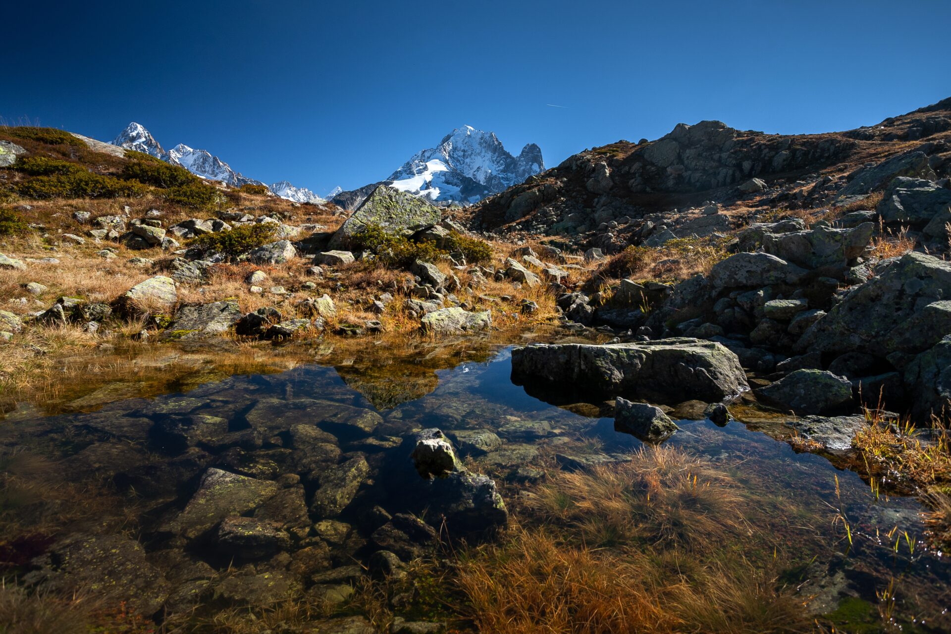 The mount Aiguille Verte from Mont Blanc massif reflecting on the water in Chamonix, France