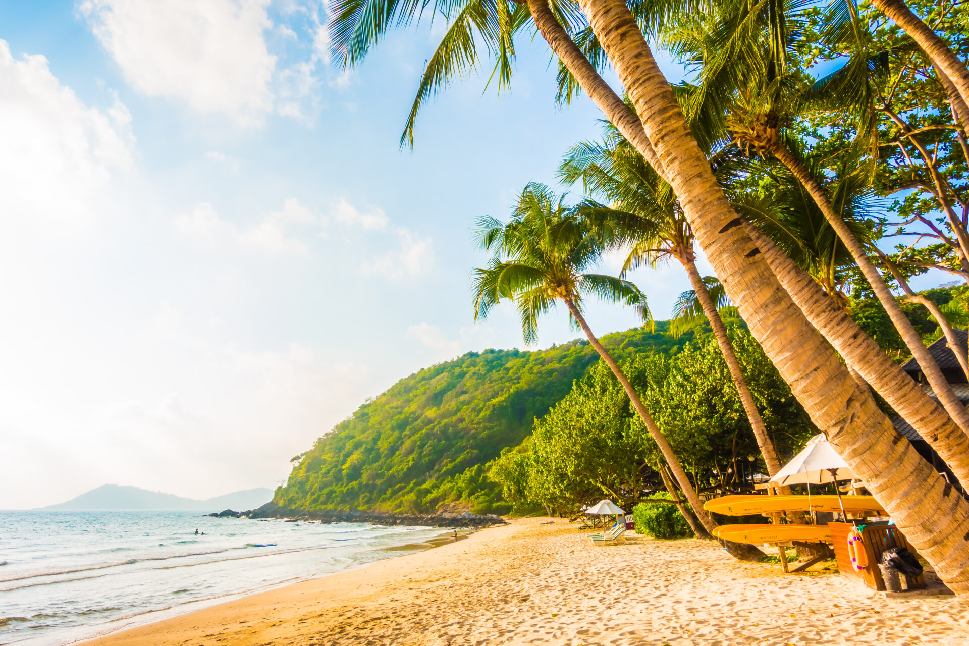 Beautiful tropical beach and sea landscape with coconut palm tree and umbrella and chair - Boost up color Processing